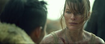 Movie still from “Monster Hunter” (2020), directed by Paul W.S. Anderson – A person with bruises on her face; Close Up shot, Over the shoulder angle