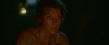 Movie still from “Monster Hunter” (2020), directed by Paul W.S. Anderson – A person with a scar on their face; Close Up shot, Over the shoulder angle