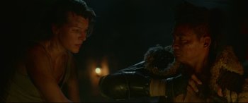 Movie still from “Monster Hunter” (2020), directed by Paul W.S. Anderson – A man and a woman looking at each other in the dark; Close Up shot, Over the shoulder angle