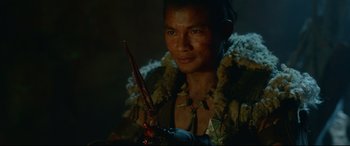 Movie still from “Monster Hunter” (2020), directed by Paul W.S. Anderson – A man holding a knife in a dark room; Close Up shot, Over the shoulder angle