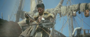 Movie still from “Monster Hunter” (2020), directed by Paul W.S. Anderson – A man in a costume holding a sword; Medium shot, Low angle