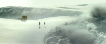 Movie still from “Monster Hunter” (2020), directed by Paul W.S. Anderson – Two skiers are skiing through the clouds on the snow; Extreme Wide shot, Low angle