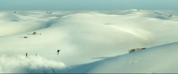 Movie still from “Monster Hunter” (2020), directed by Paul W.S. Anderson – A person is skiing down a snowy slope; Extreme Wide shot, High angle