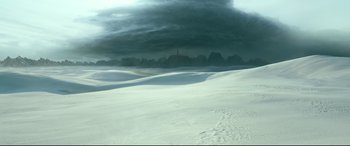 Movie still from “Monster Hunter” (2020), directed by Paul W.S. Anderson – A snowy field with a dark sky in the background; Extreme Wide shot, High angle
