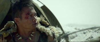 Movie still from “Monster Hunter” (2020), directed by Paul W.S. Anderson – A man holding a bunch of flowers in his hands; Close Up shot, Over the shoulder angle