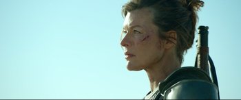 Movie still from “Monster Hunter” (2020), directed by Paul W.S. Anderson – A person with a knife on their face; Close Up shot, Low angle