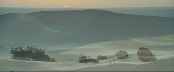 Movie still from “Monster Hunter” (2020), directed by Paul W.S. Anderson – A car parked on top of a snow covered field; Extreme Wide shot, High angle