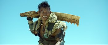 Movie still from “Monster Hunter” (2020), directed by Paul W.S. Anderson – A man with a large animal horn on his head; Medium shot, Low angle