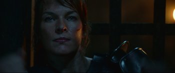 Movie still from “Monster Hunter” (2020), directed by Paul W.S. Anderson – A person with a gun in a room; Close Up shot, Over the shoulder angle