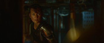 Movie still from “Monster Hunter” (2020), directed by Paul W.S. Anderson – A woman with a sword and a helmet on her shoulder; Close Up shot, Over the shoulder angle