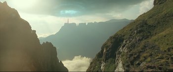 Movie still from “Monster Hunter” (2020), directed by Paul W.S. Anderson – A view of a mountain range with clouds in the background; Extreme Wide shot, Low angle