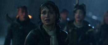 Movie still from “Monster Hunter” (2020), directed by Paul W.S. Anderson – A woman in a black jacket and a white scarf; Close Up shot, Over the shoulder angle