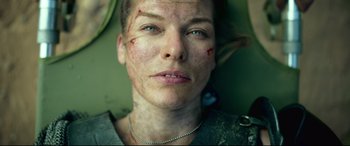 Movie still from “Monster Hunter” (2020), directed by Paul W.S. Anderson – A person with a scar on their face; Close Up shot, Low angle