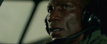 Movie still from “Monster Hunter” (2020), directed by Paul W.S. Anderson – A person wearing a headset; Close Up shot, High angle