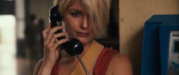 Movie still from “Monsters” (2010), directed by Gareth Edwards – A woman holding a phone up to her ear; Close Up shot, Low angle