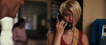 Movie still from “Monsters” (2010), directed by Gareth Edwards – A woman holding a phone up to her ear; Close Up shot, High angle