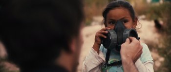 Movie still from “Monsters” (2010), directed by Gareth Edwards – A little girl taking a picture of a man with a camera; Close Up shot, Over the shoulder angle