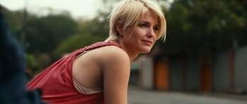 Movie still from “Monsters” (2010), directed by Gareth Edwards – A woman with blonde hair is posing for a picture; Close Up shot, Low angle