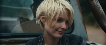 Movie still from “Monsters” (2010), directed by Gareth Edwards – A person with short blonde hair; Close Up shot, Over the shoulder angle