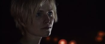 Movie still from “Monsters” (2010), directed by Gareth Edwards – A person's face at night; Close Up shot, Low angle