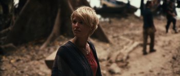 Movie still from “Monsters” (2010), directed by Gareth Edwards – A woman with short blonde hair standing on the beach; Close Up shot, Over the shoulder angle