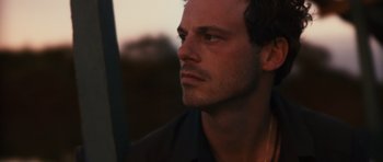 Movie still from “Monsters” (2010), directed by Gareth Edwards – A person looking at the camera; Close Up shot, Low angle
