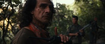 Movie still from “Monsters” (2010), directed by Gareth Edwards – A man with long curly hair holding a microphone; Close Up shot, Over the shoulder angle