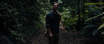 Movie still from “Monsters” (2010), directed by Gareth Edwards – A man standing in the middle of a path in the woods; Medium shot, Low angle