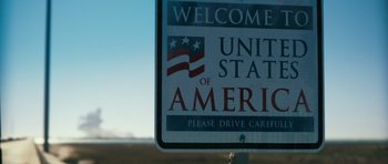 Movie still from “Monsters” (2010), directed by Gareth Edwards – A welcome to america sign; Extreme Wide shot, Low angle