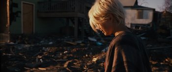 Movie still from “Monsters” (2010), directed by Gareth Edwards – A young boy standing in the middle of a pile of trash; Medium shot, Low angle