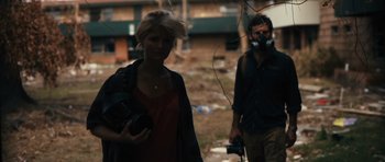 Movie still from “Monsters” (2010), directed by Gareth Edwards – A woman and a man are walking in the dirt; Medium shot, Low angle