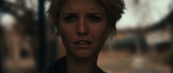 Movie still from “Monsters” (2010), directed by Gareth Edwards – A woman's face in a dimly - lit room; Close Up shot, Low angle