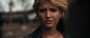 Movie still from “Monsters” (2010), directed by Gareth Edwards – A person with short blonde hair; Close Up shot, Over the shoulder angle