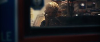 Movie still from “Monsters” (2010), directed by Gareth Edwards – A woman talking on a cell phone while sitting in a car; Close Up shot, Over the shoulder angle