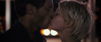 Movie still from “Monsters” (2010), directed by Gareth Edwards – A man and a woman kissing in front of a street light at night; Close Up shot, Over the shoulder angle