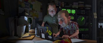 Movie still from “Monsters vs. Aliens” (2009), directed by Conrad Vernon – Two men are looking at a laptop computer; Medium shot, Over the shoulder angle