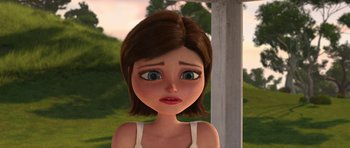 Movie still from “Monsters vs. Aliens” (2009), directed by Conrad Vernon – An animated girl with brown hair and green eyes looking sad; Close Up shot, Over the shoulder angle