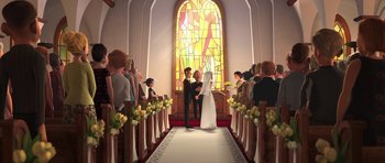 Movie still from “Monsters vs. Aliens” (2009), directed by Conrad Vernon – A bride and groom are standing in front of a stained - glass window; Wide shot, Low angle