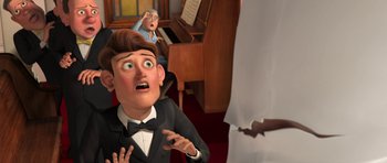 Movie still from “Monsters vs. Aliens” (2009), directed by Conrad Vernon – An animated scene of a man in a suit and bow tie; Medium shot, Over the shoulder angle
