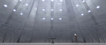 Movie still from “Monsters vs. Aliens” (2009), directed by Conrad Vernon – A person standing in a room with a chair and a table; Extreme Wide shot, High angle