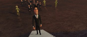 Movie still from “Monsters vs. Aliens” (2009), directed by Conrad Vernon – A cartoon of a man in a business suit standing in front of a group of men; Wide shot, High angle
