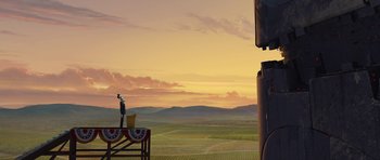 Movie still from “Monsters vs. Aliens” (2009), directed by Conrad Vernon – An image of a man standing on top of a table; Extreme Wide shot, Low angle