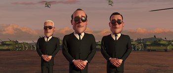 Movie still from “Monsters vs. Aliens” (2009), directed by Conrad Vernon – A group of men in black suits and sunglasses standing next to each other in front of an airplane; Medium shot, High angle