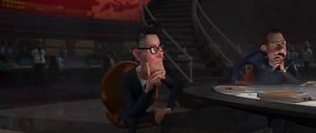 Movie still from “Monsters vs. Aliens” (2009), directed by Conrad Vernon – An animated man sitting in front of a table; Medium shot, Over the shoulder angle