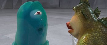 Movie still from “Monsters vs. Aliens” (2009), directed by Conrad Vernon – A person holding an apple in front of a blue creature; Close Up shot, Over the shoulder angle