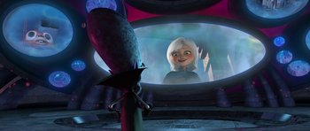 Movie still from “Monsters vs. Aliens” (2009), directed by Conrad Vernon – A woman is looking into a mirror in a room; Medium shot, Over the shoulder angle