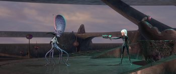 Movie still from “Monsters vs. Aliens” (2009), directed by Conrad Vernon – An animated scene of a woman holding a gun and a squid; Wide shot, Over the shoulder angle