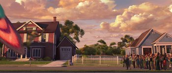 Movie still from “Monsters vs. Aliens” (2009), directed by Conrad Vernon – An illustration of a house with a fence and trees in the background; Extreme Wide shot, Low angle