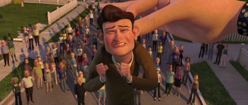 Movie still from “Monsters vs. Aliens” (2009), directed by Conrad Vernon – An animated character being held down by a crowd of onlookers; Medium shot, High angle