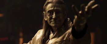 Movie still from “Moon Knight” (2022), directed by Mohamed Diab – An old man with long hair wearing a gold costume; Close Up shot, Low angle